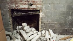 Insulating exterior basement wall around old brick fireplace