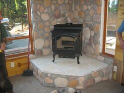 How do I build a cultured stone wall as a fireback for my stove