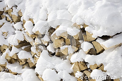 firewood-covered-snow-12821030.jpg