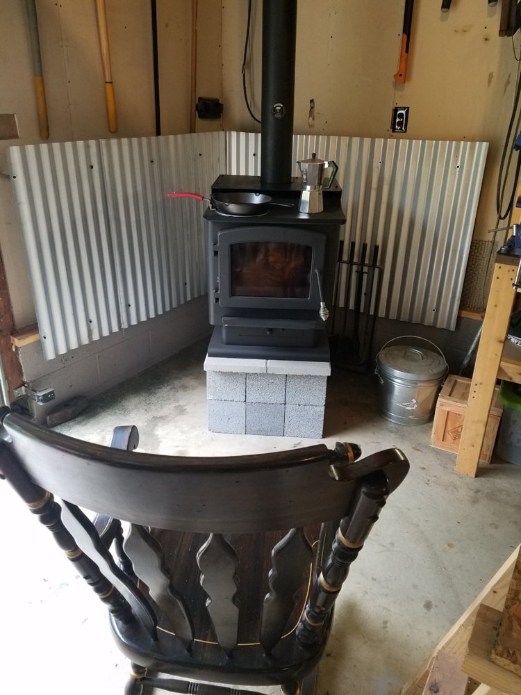 Wood stove with heat shield. Metal studs installed sideways, then