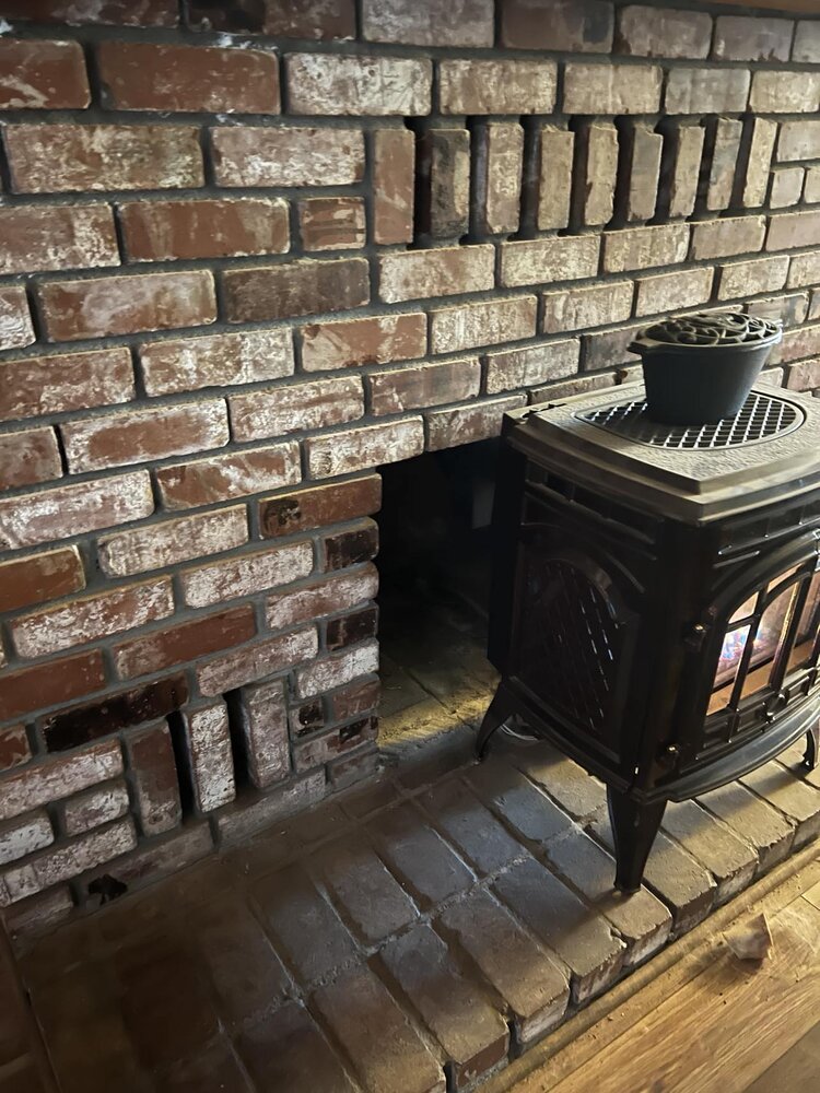 Former wood fireplace converted to propane stove in front
