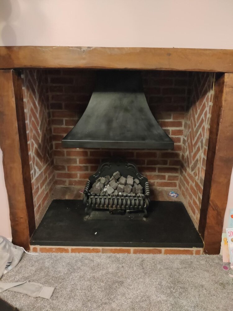 Do I need to replace wooden fireplace surround for wood burning stove?