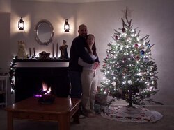 Christmas picture of the wife and I (There's a fireplace in the picture)