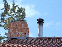 Metal Flue near masonry chimney