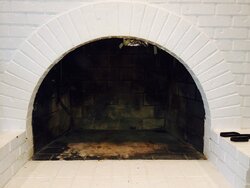 Larger stove in fireplace or smaller out of fireplace?