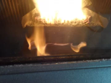 [Hearth.com] Fire behind the burn pot of a Harman Accentra FS...