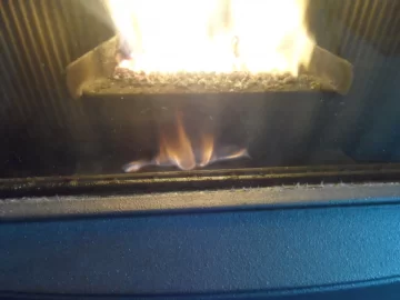 [Hearth.com] Fire behind the burn pot of a Harman Accentra FS...