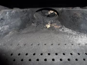 [Hearth.com] Fire behind the burn pot of a Harman Accentra FS...