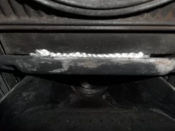 [Hearth.com] Fire behind the burn pot of a Harman Accentra FS...