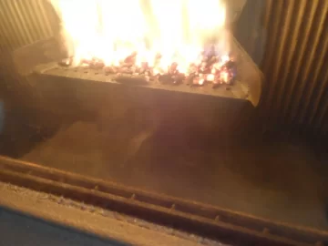[Hearth.com] Fire behind the burn pot of a Harman Accentra FS...