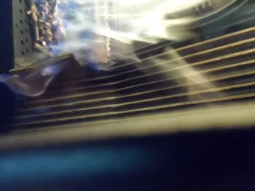 [Hearth.com] Fire behind the burn pot of a Harman Accentra FS...