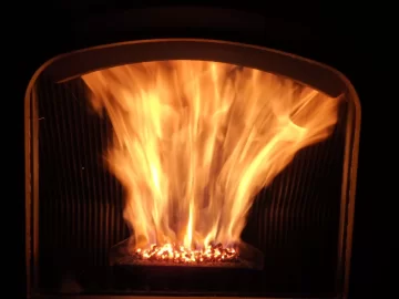 [Hearth.com] Fire behind the burn pot of a Harman Accentra FS...