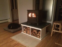 A woodstove storyVermont Castings Intrepid on soapstone hearth with built in wood box