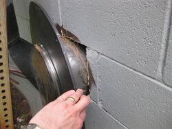 Best way to seal up masonry around a chimney thimble?