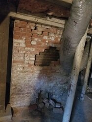 Crumbling brick chimney stack in 120 year old home
