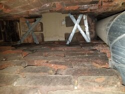 Crumbling brick chimney stack in 120 year old home