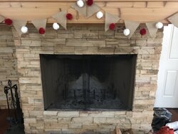 Standing wood stove in prefab fireplace