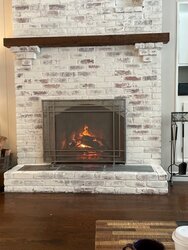 Wood-burning insert for arched fireplace