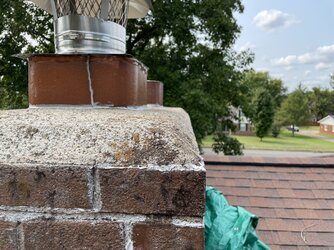 Stainless cover vs full chimney cap over masonry crown