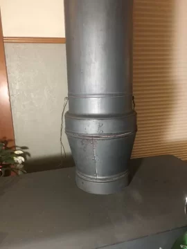 Placement of damper with wood stove flue which increases in diameter?