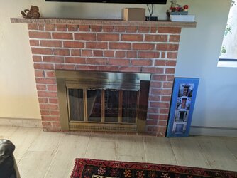 Wood stove clearance in a masonry fireplace