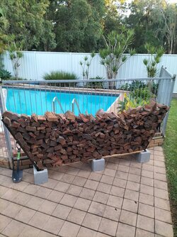 Diy firewood storage using bricks and fence pairings treated with arson