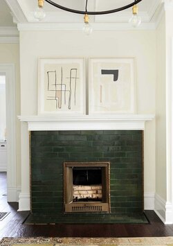 23-a-hunter-green-brick-fireplace-with-copper-detailing-and-abstract-artworks-on-the-mantel-l...jpeg