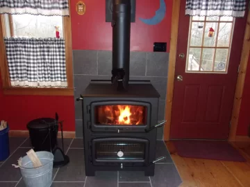 Would slate tiles on wall be a good idea even if recommended clearance behind stove is met?