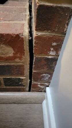 Brick hearth separating from main fireplace structure.