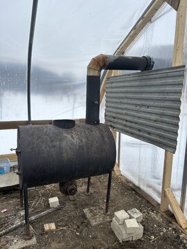 Barrel stove in a greenhouse