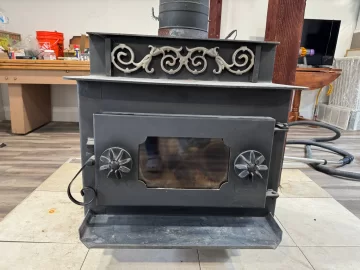 [Hearth.com] Step-top steel box stove ID — pinwheel draft caps + brass filigree