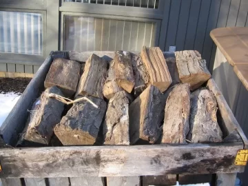 [Hearth.com] Wood storage outside the side door.