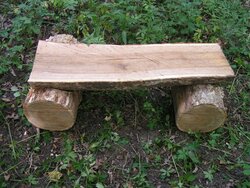new white oak bench  in roundabout on trail.JPG