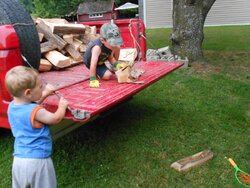 Boys helping me get the woodshed filled