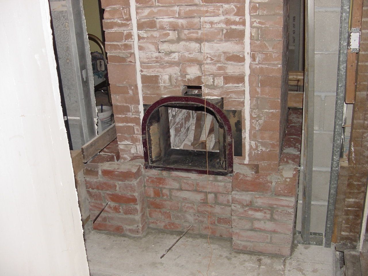 Inside core build w. refractory brick. Door was salvaged from Fireplace insert and had brackets attached to mount it within the brick work.